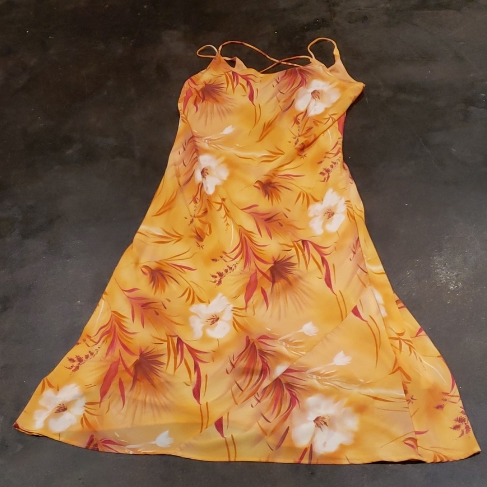 Orange/peach colored dress with flowers.